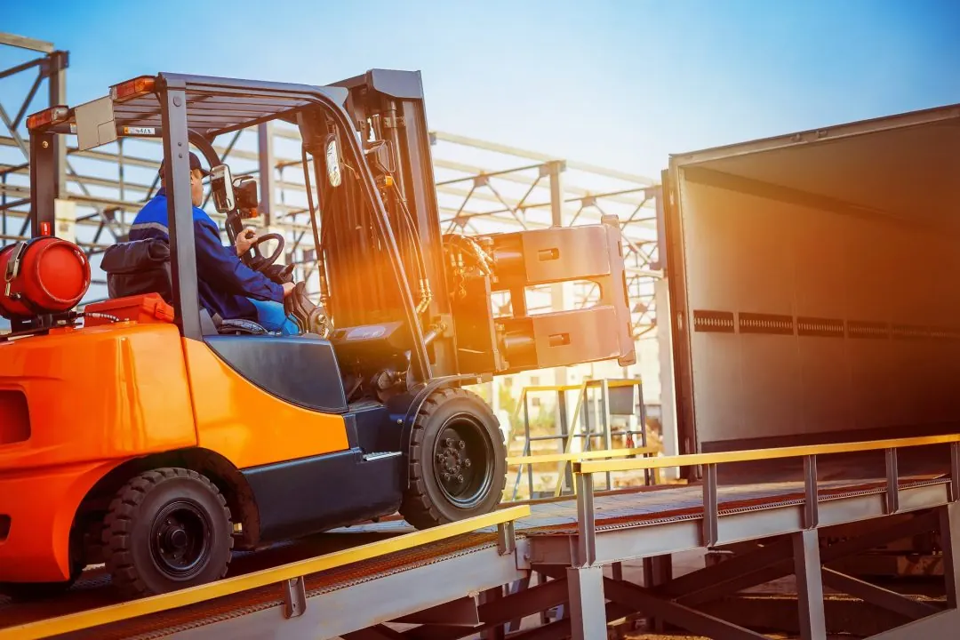 Forklift loading a vehicle during industrial training
